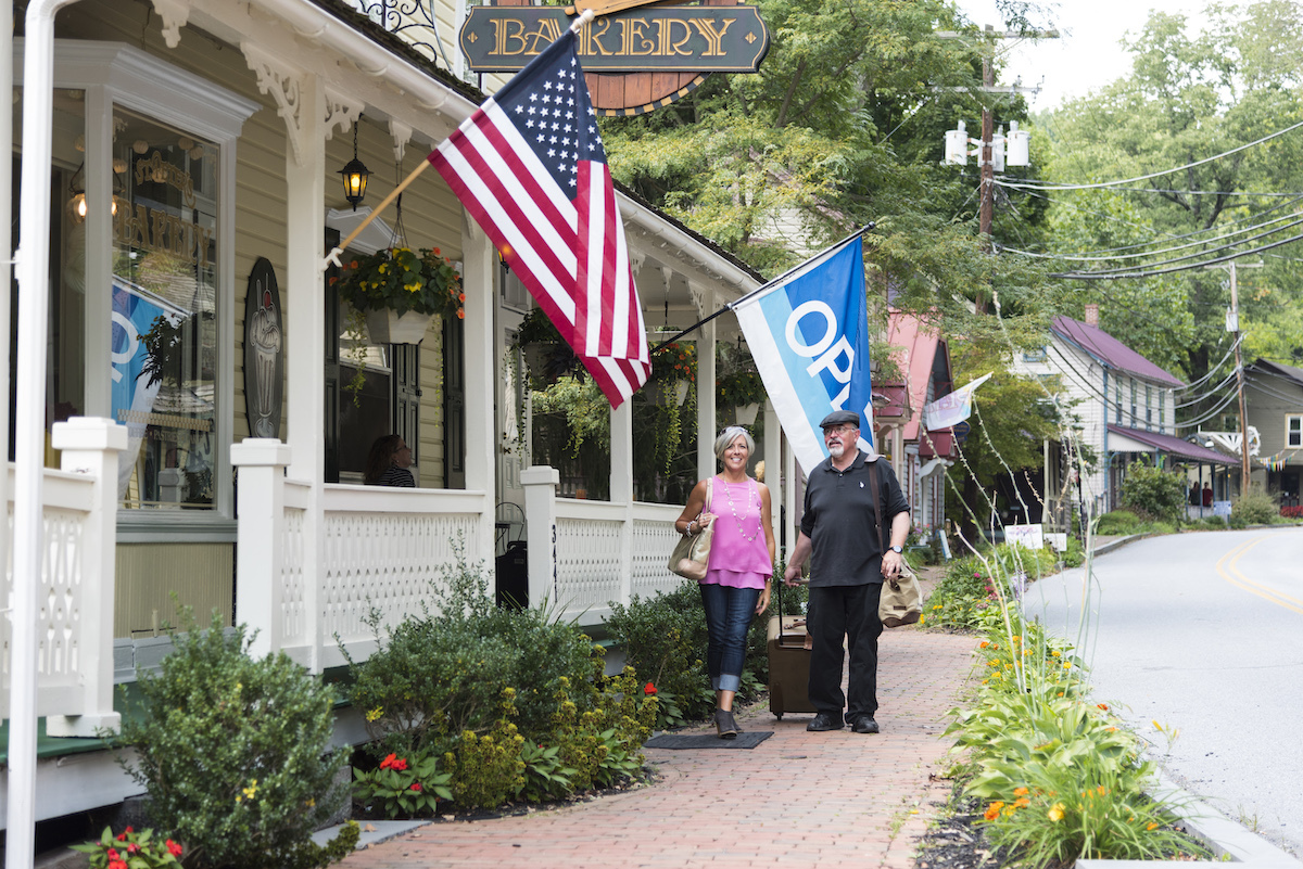 Historic St. Peter's Village, Pennsylvania downtown. A couple walks past a bakery.