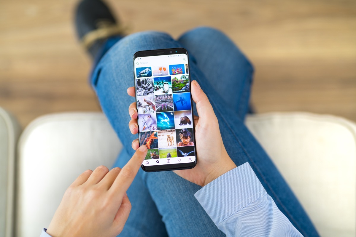 woman using smart phone on a couch