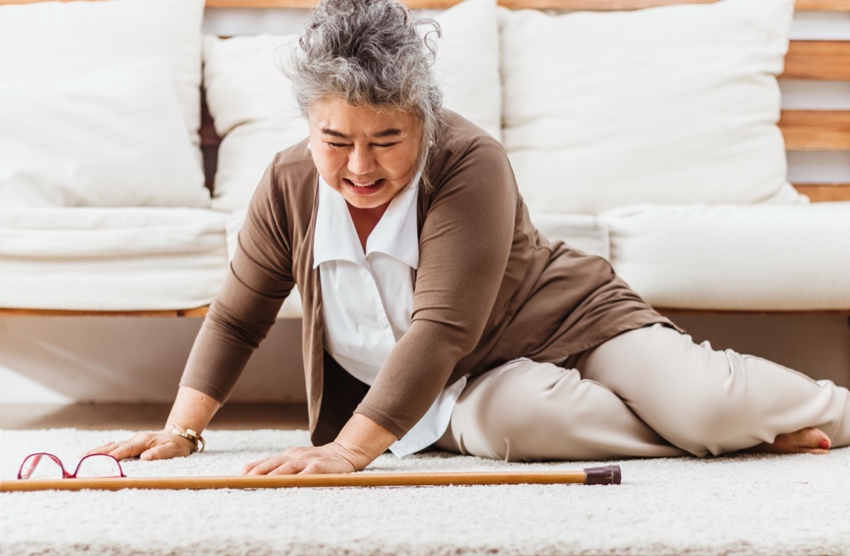 older woman who fell in front of sofa at home