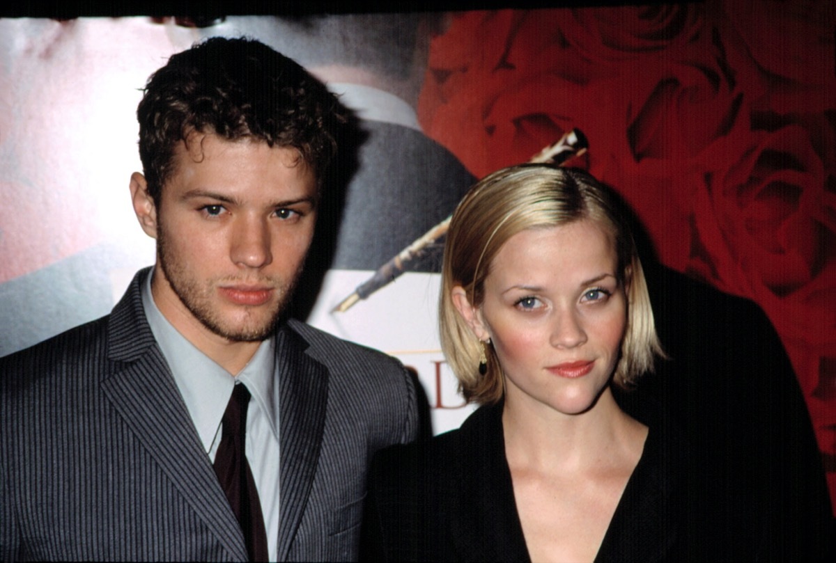 Reese Witherspoon wears a black jacket and Ryan Phillippe wears a grey suit at the premiere of 'Gosford Park' in 2001