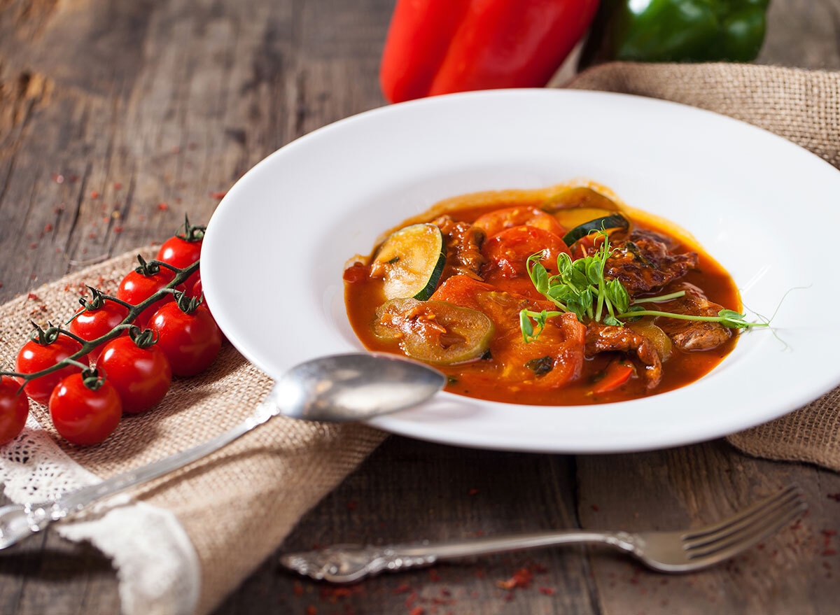 zucchini stew in white glass bowl