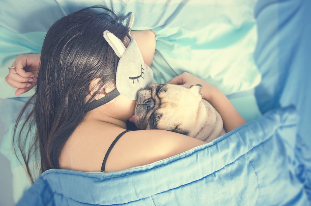 woman napping with pug