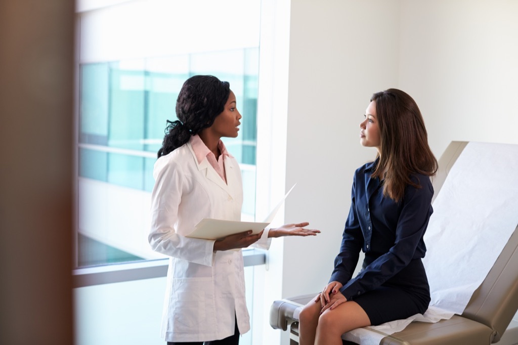 doctor talking to a female patient at a checkup