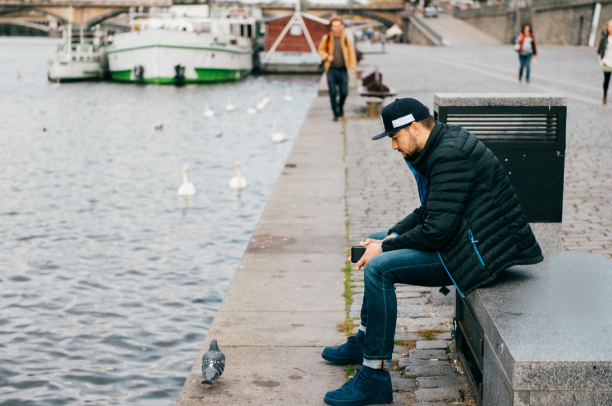 Lonely man sitting on bench