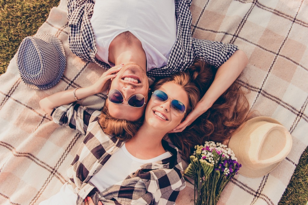 Young Couple sitting on a Picnic Blanket, open marriage