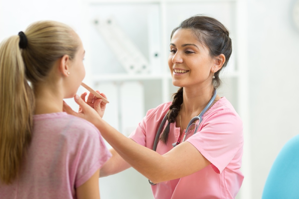 nurse examining student with tongue depressor, school nurse secrets