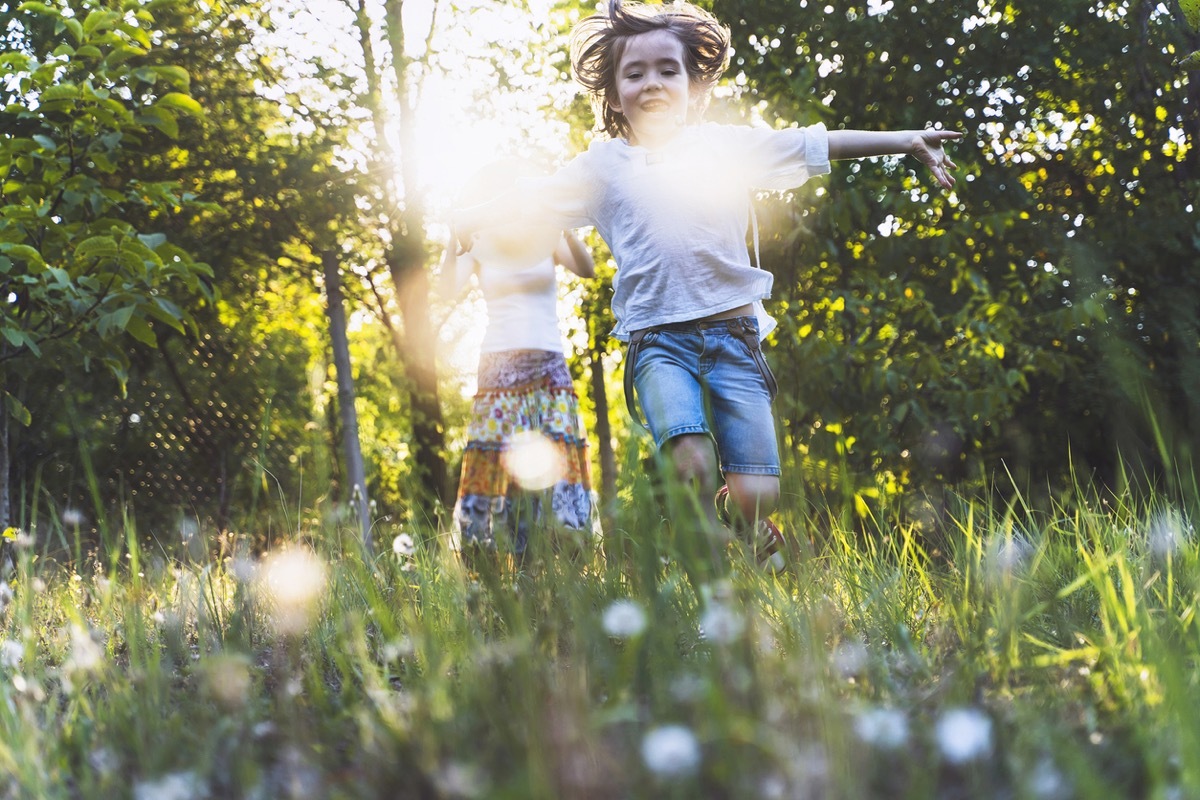 Happy family enjoying the good weather in the backyard. Summer, spring. Social isolation during the COVID-19 pandemic.