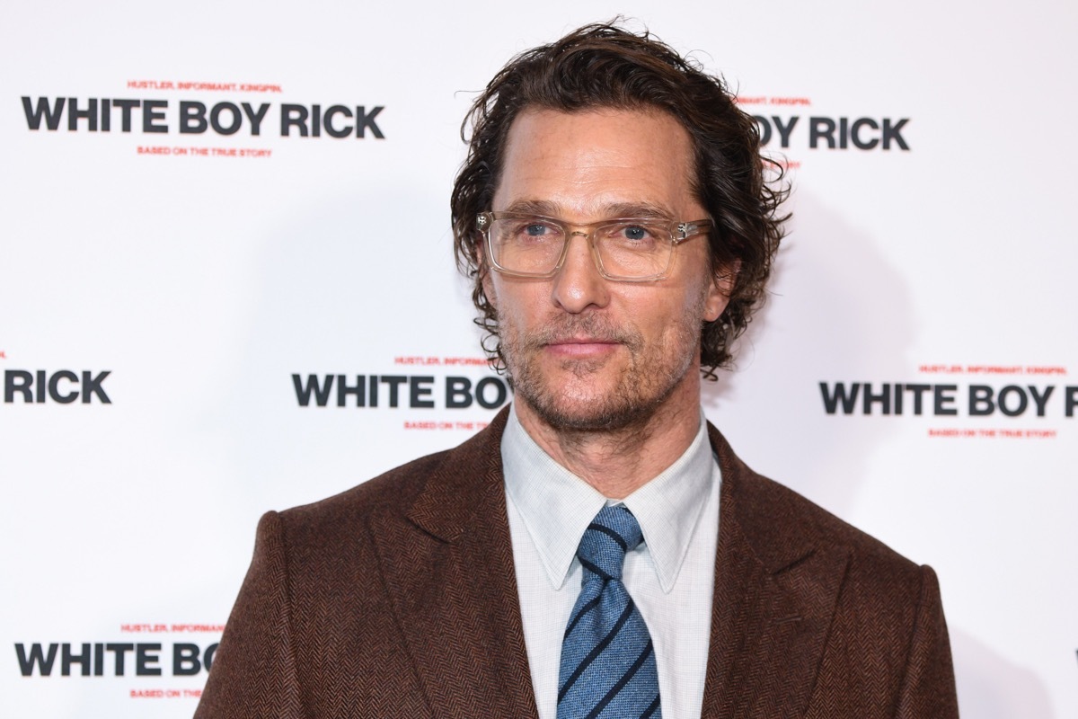 matthew mcconaughey in brown suit in front of step and repeat