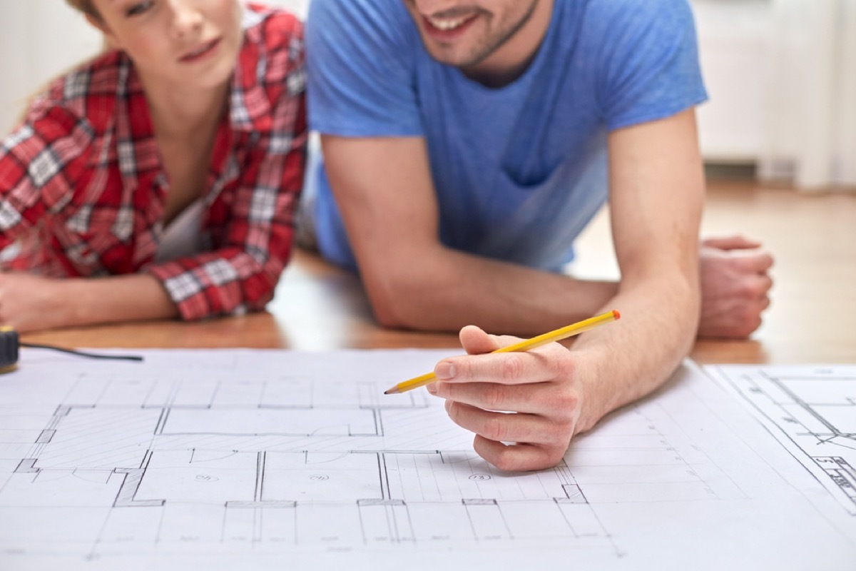 couple looking at blueprint worst home upgrades