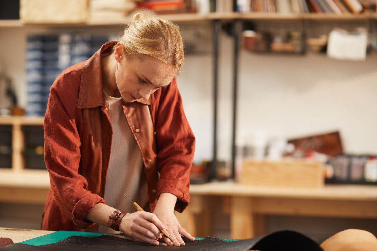 Woman cutting fabric for craft