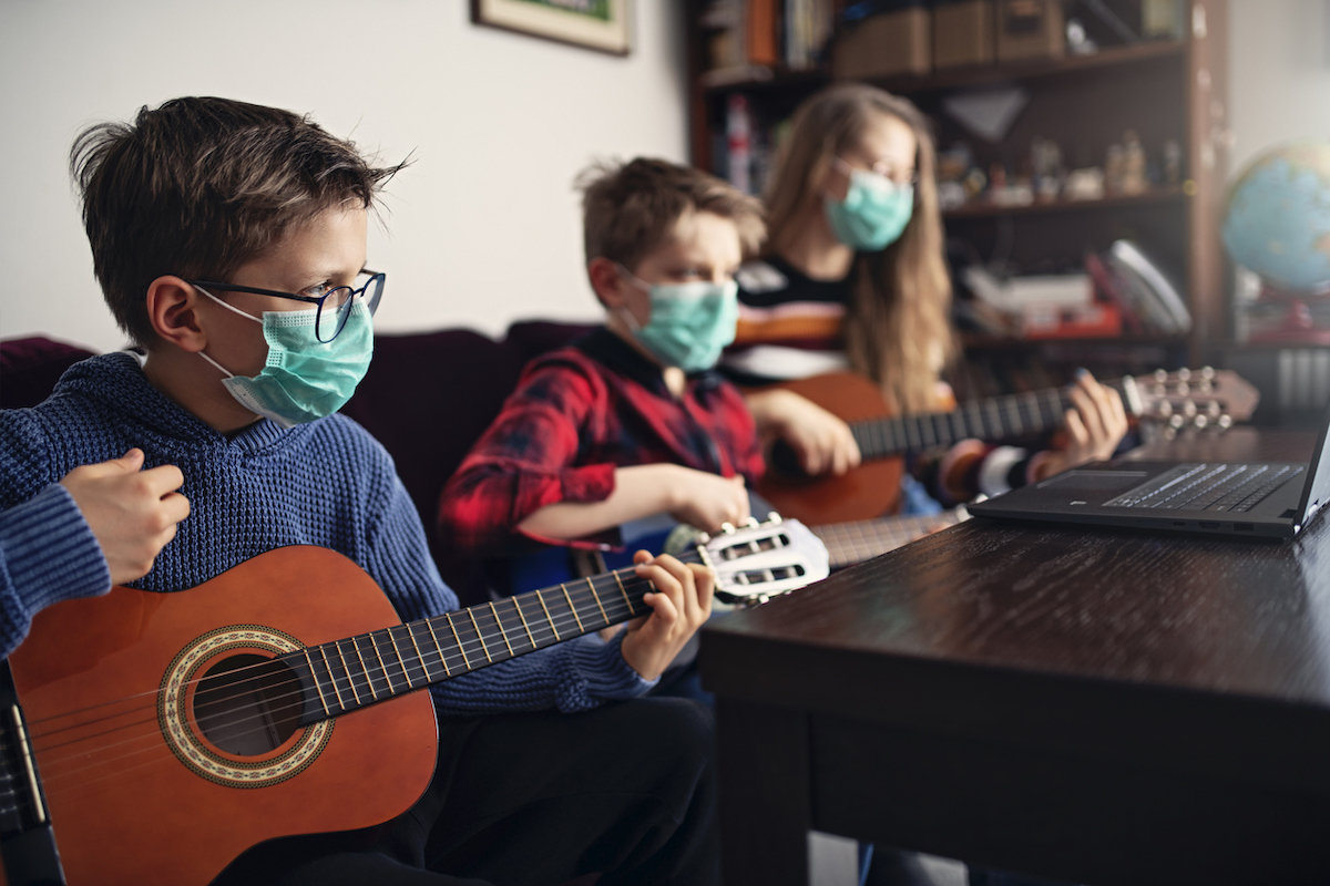 Sister and brothers having fun playing music together