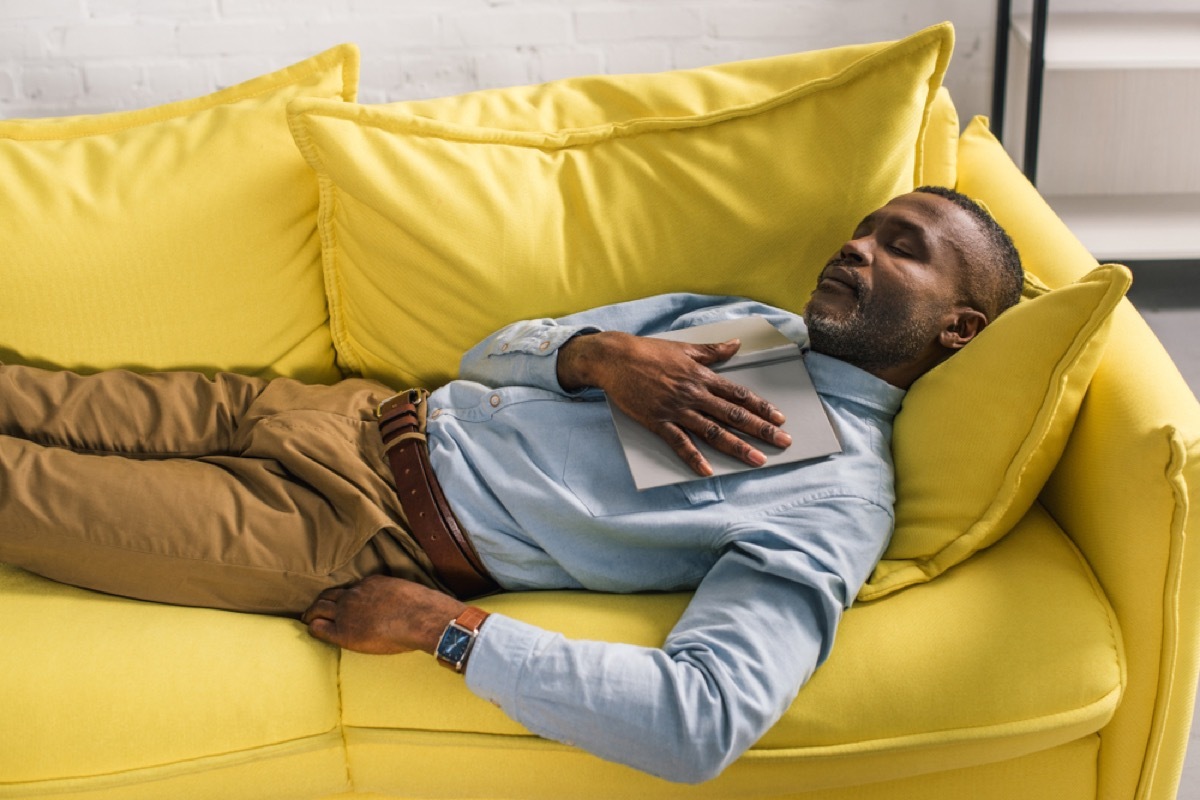 middle-aged man napping on yellow couch, ways to be a healthier man