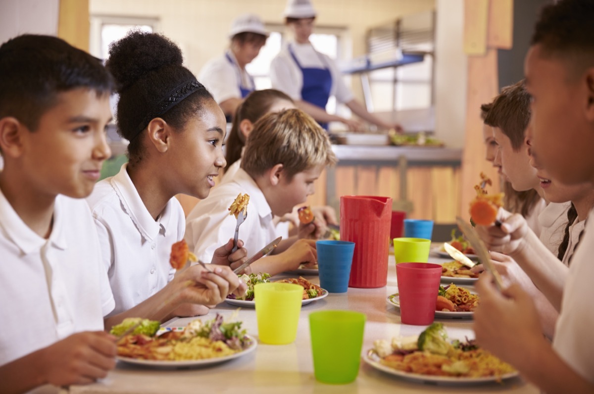 Kids eating lunch together at school in cafeteria