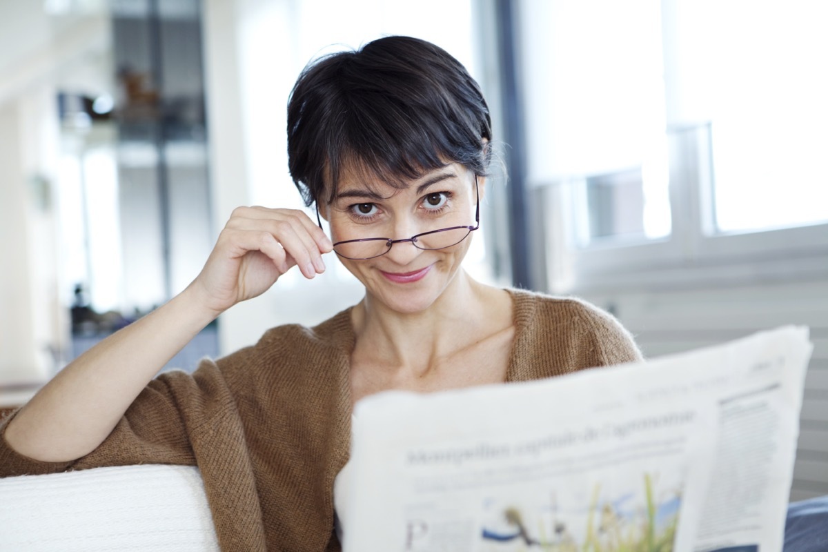 woman tilting her glasses down