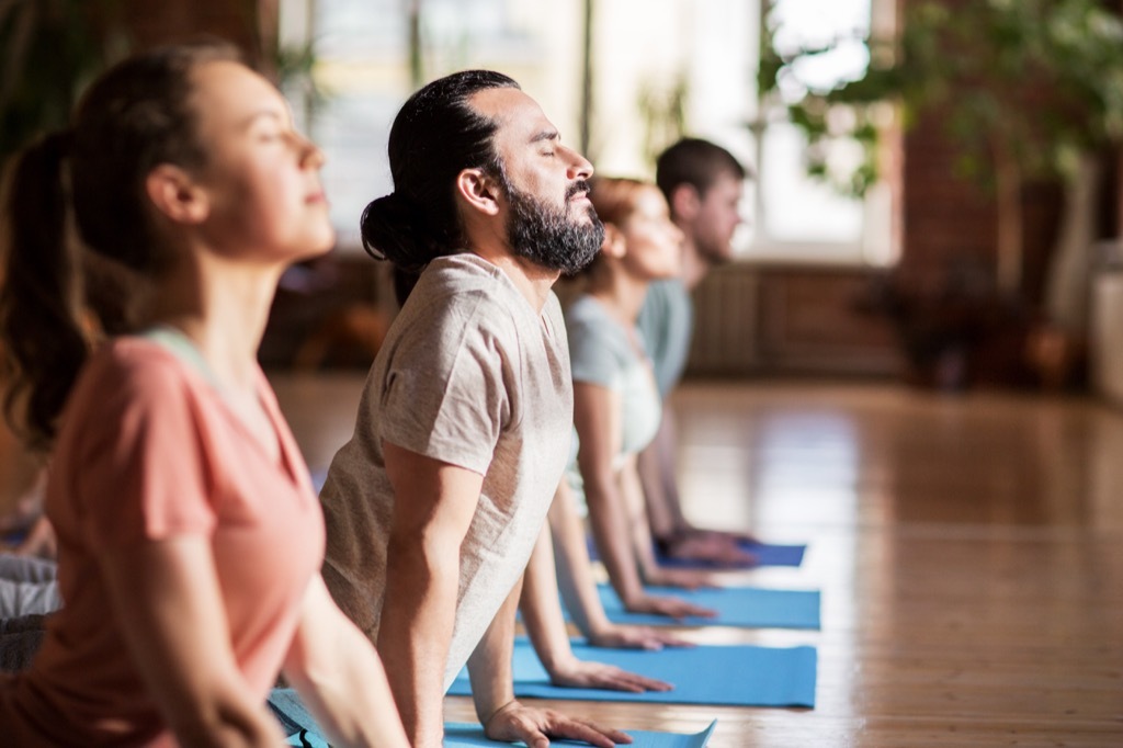 middle aged people doing yoga