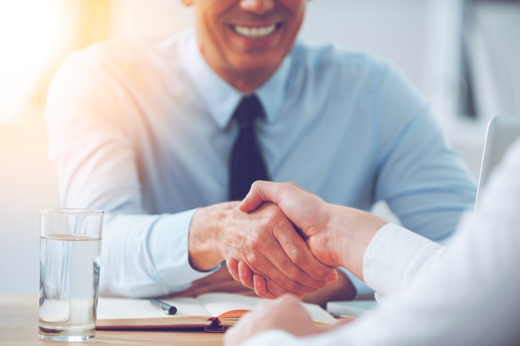 Two colleagues shaking hands college professor secrets