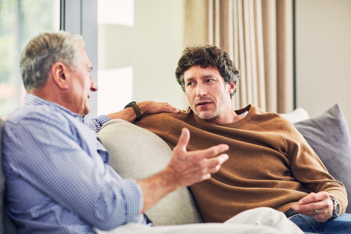 old man having a serious conversation with his elderly father