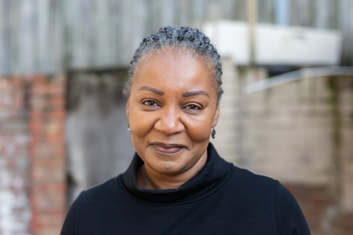 Woman wearing black turtleneck. 