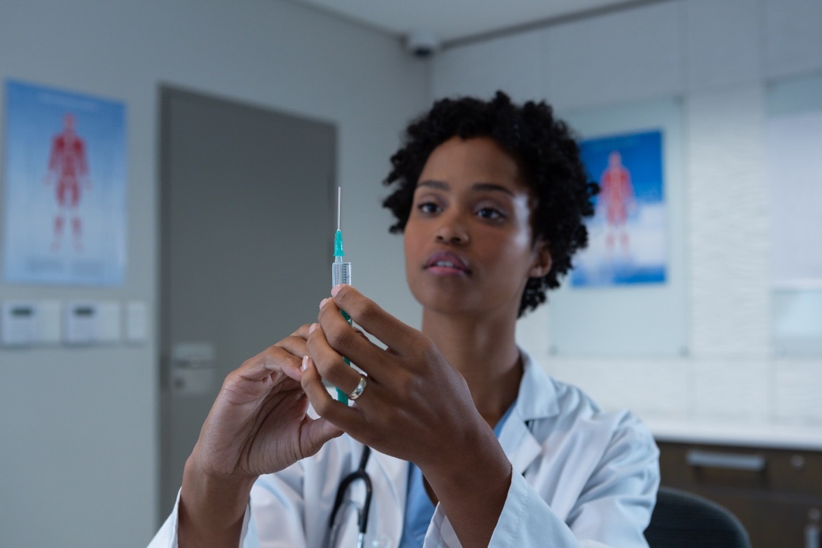 Doctor getting read to vaccinate patient with shot