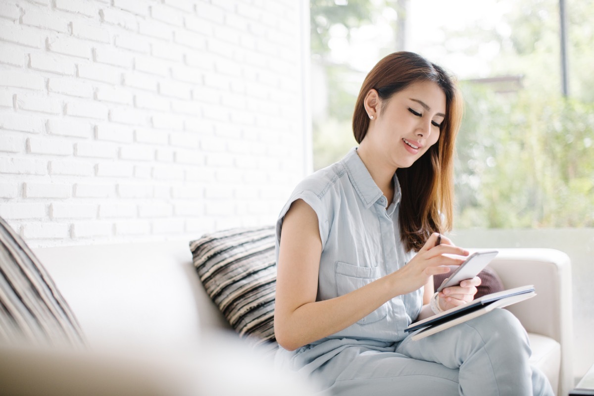 asian woman texting on smartphone