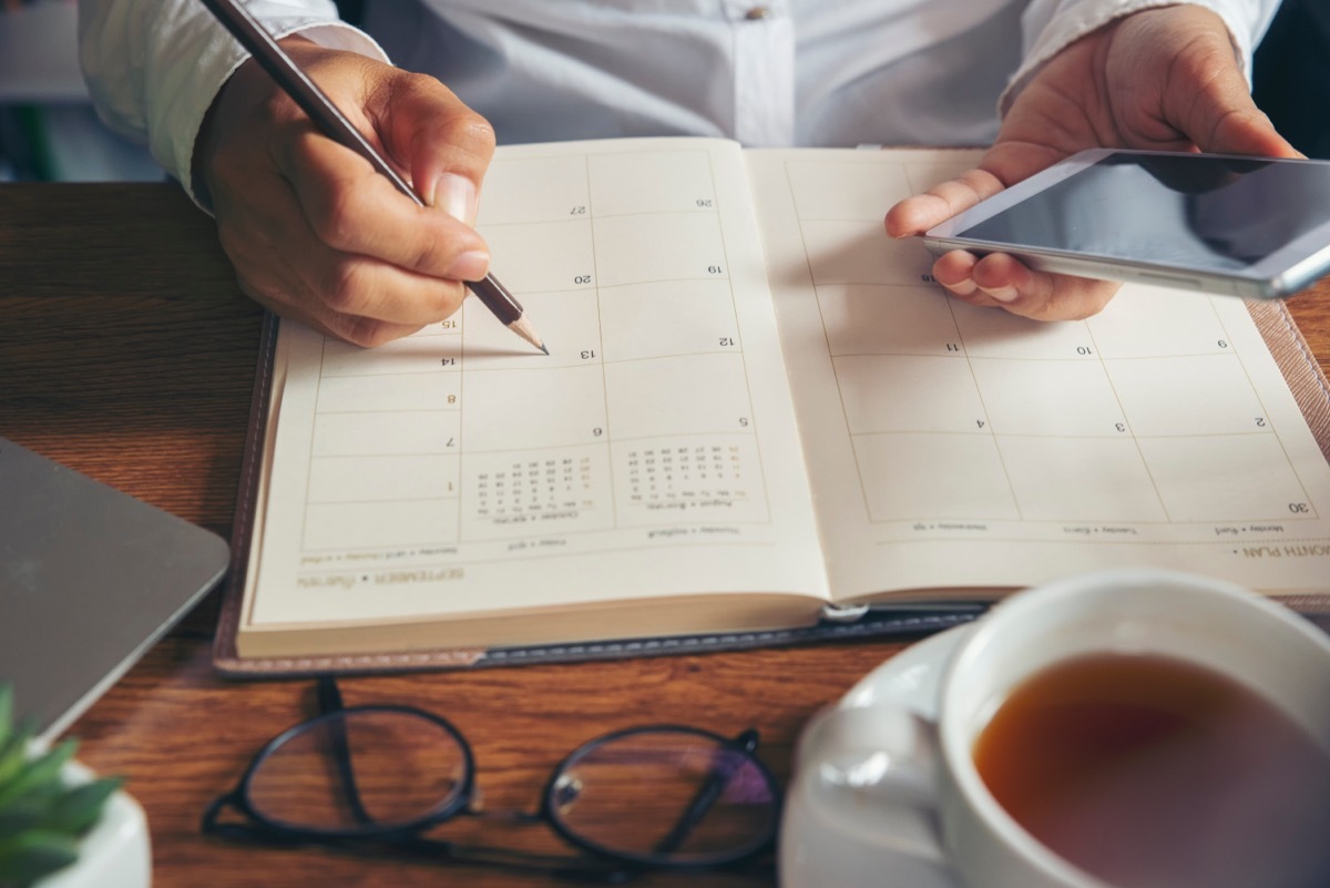 Person About to Write in a Calendar