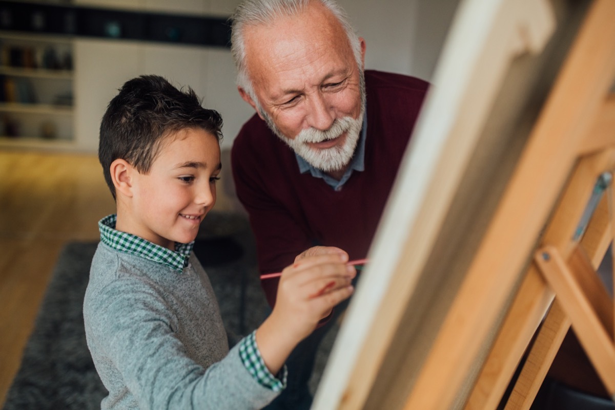 mentor helping a child paint