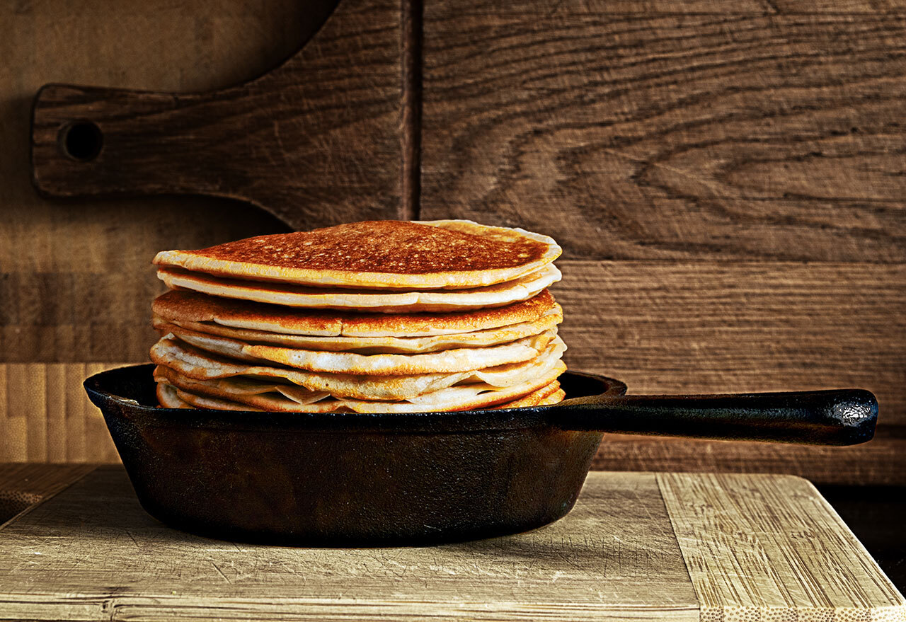 stack of pancakes in cast iron skillet