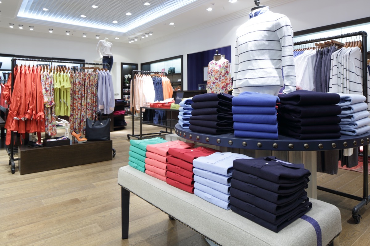 clothes folded, hung, and on mannequins in a store