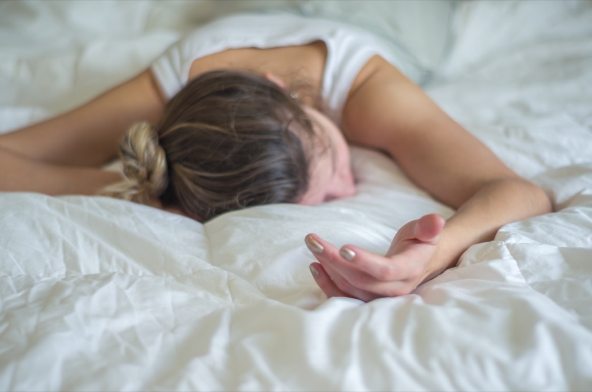 Young woman, blond hair, fainted in bed.