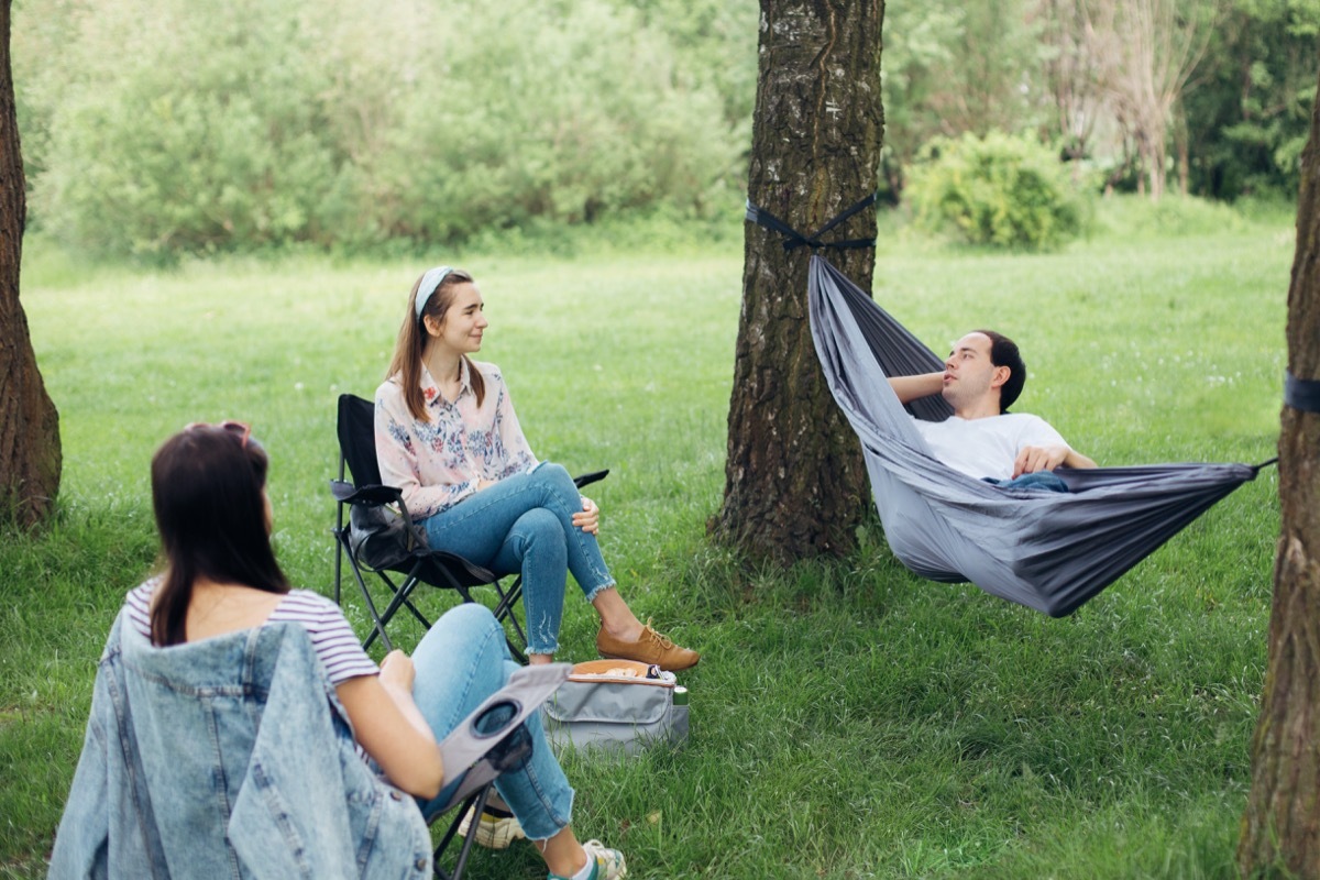 Small group of friends hanging out in yard