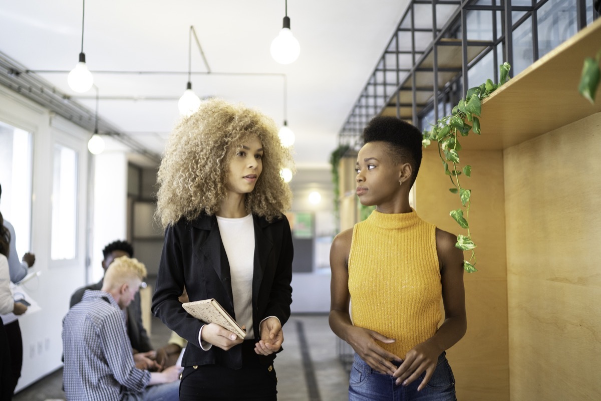 Two businesswoman walking at modern office