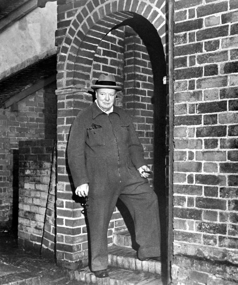 HRAC98 Winston Churchill relaxing in a siren suit smoking a cigar