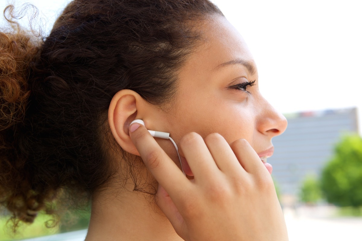 woman listening to music with earphones in ears