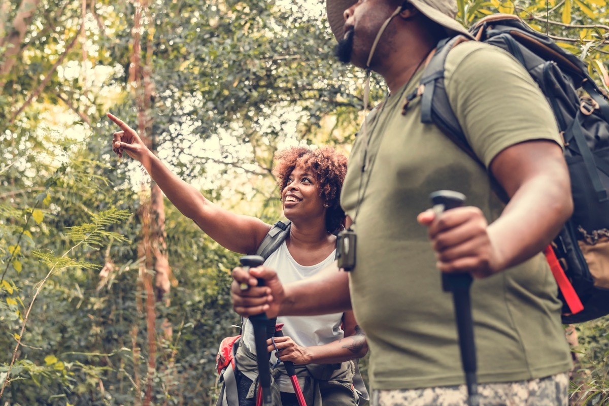 Black couple hiking in the forest together