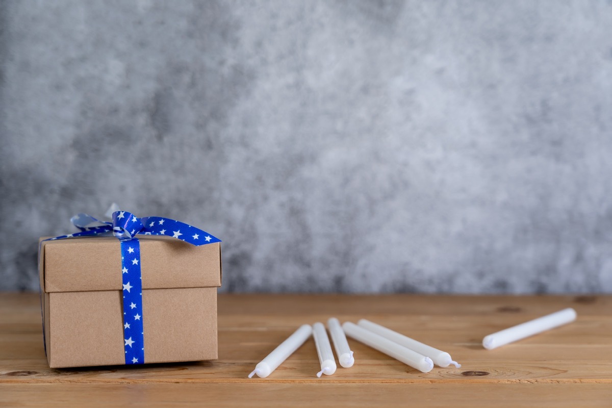 box of hanukkah candles next to cardboard box with blue bow