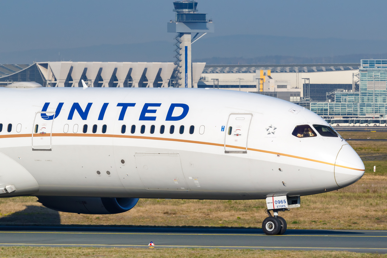 A United Airlines plane on the runway at an airport