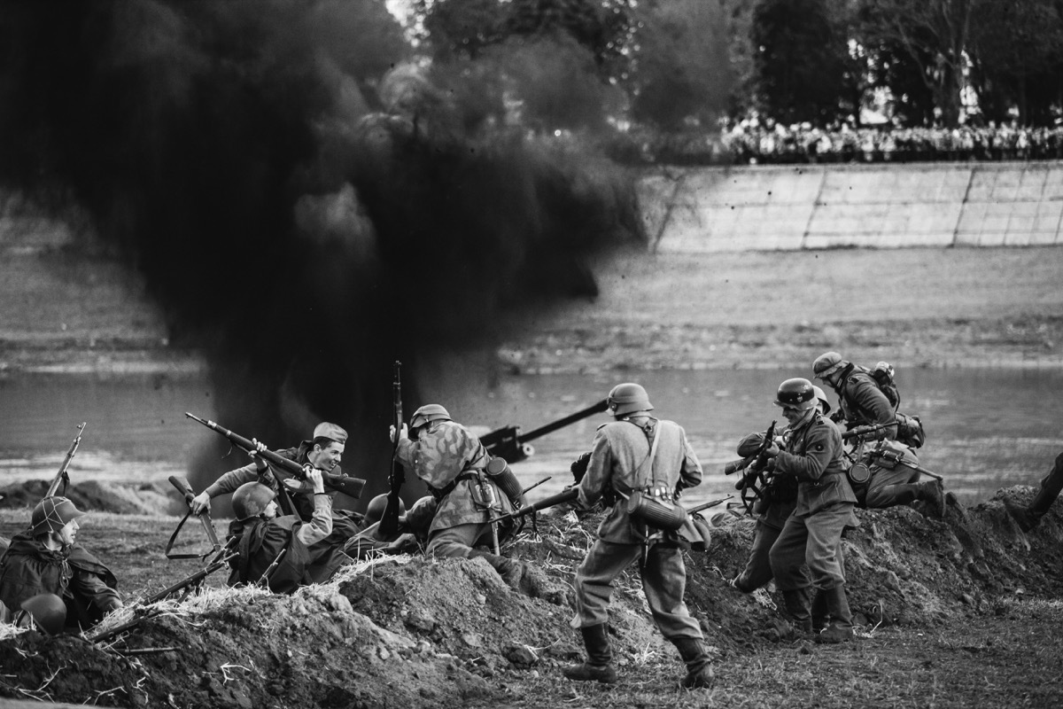 Re-enactors Dressed As German Wehrmacht Infantry Soldiers And Russian Soviet Red Army Soldiers World War II Play A Melee Scene About Fighting In Trenches