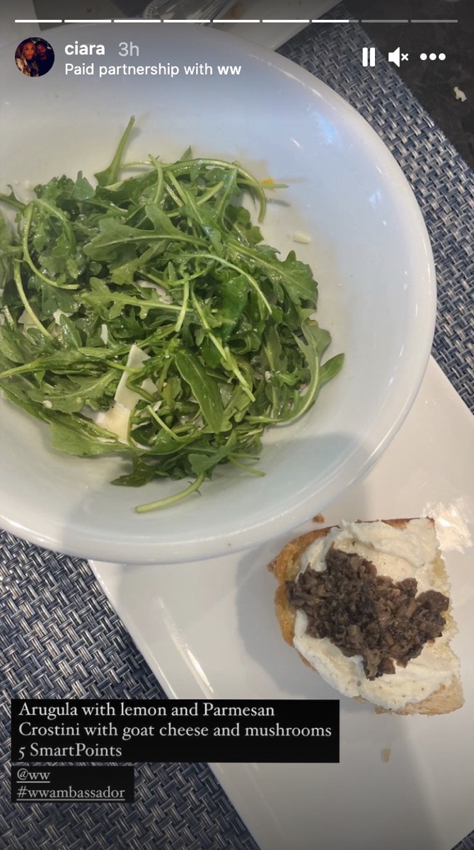 arugula salad and a mushroom crostini on white plates in instagram screenshot