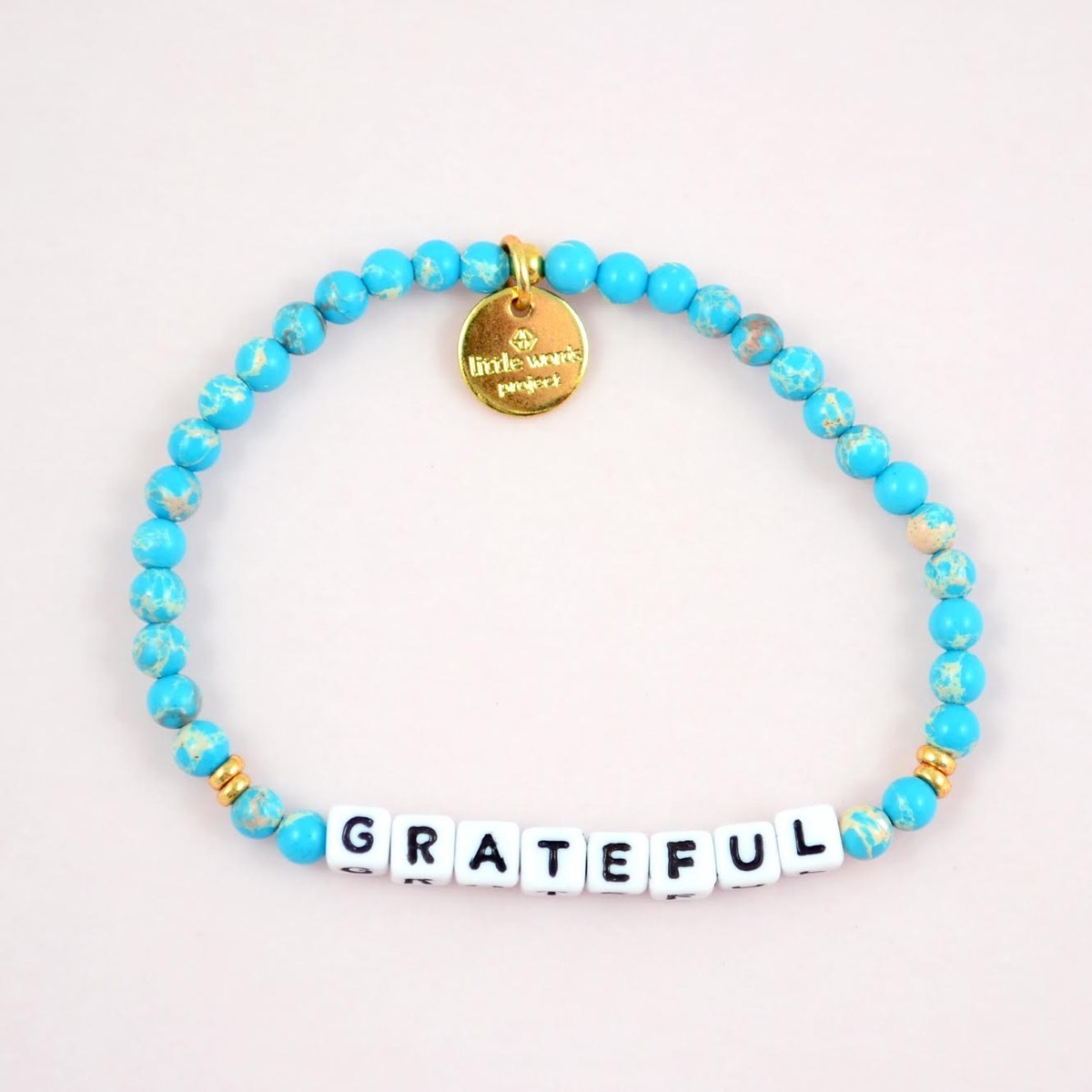 blue bracelet with grateful on it, little words project