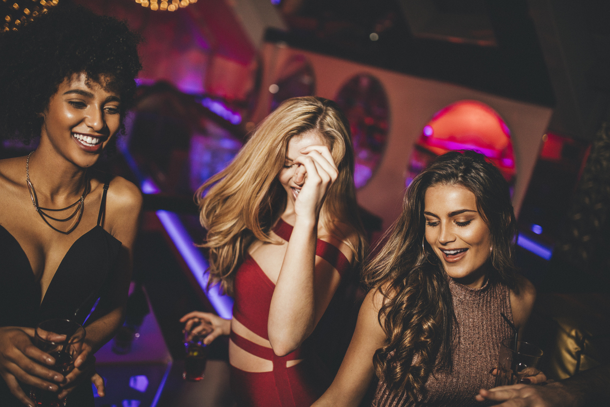 Group of friends having fun, partying in a nightclub on New Years Eve.