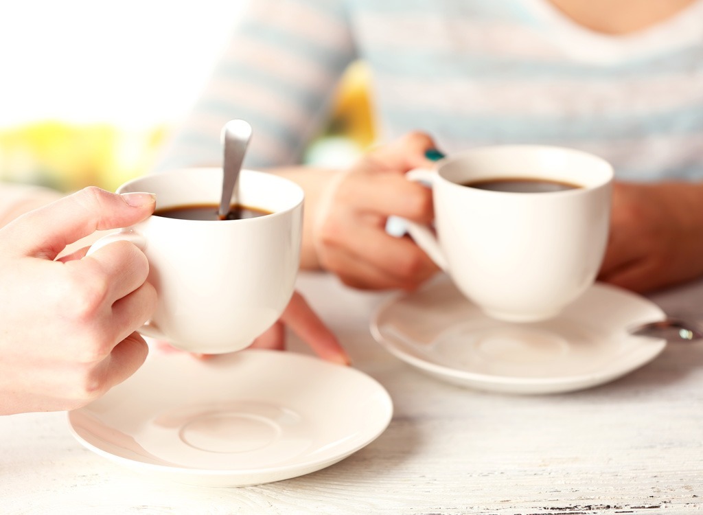 Two people holding coffee cups