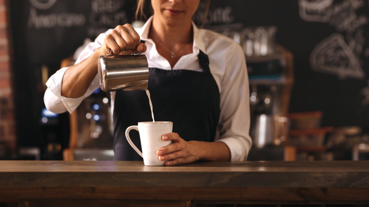 barista pouring coffee