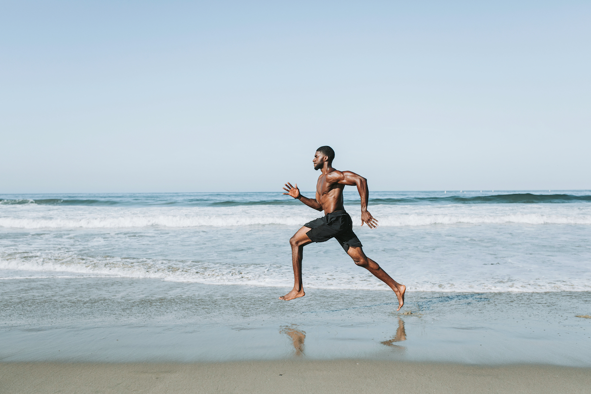 Fit man running at the beach