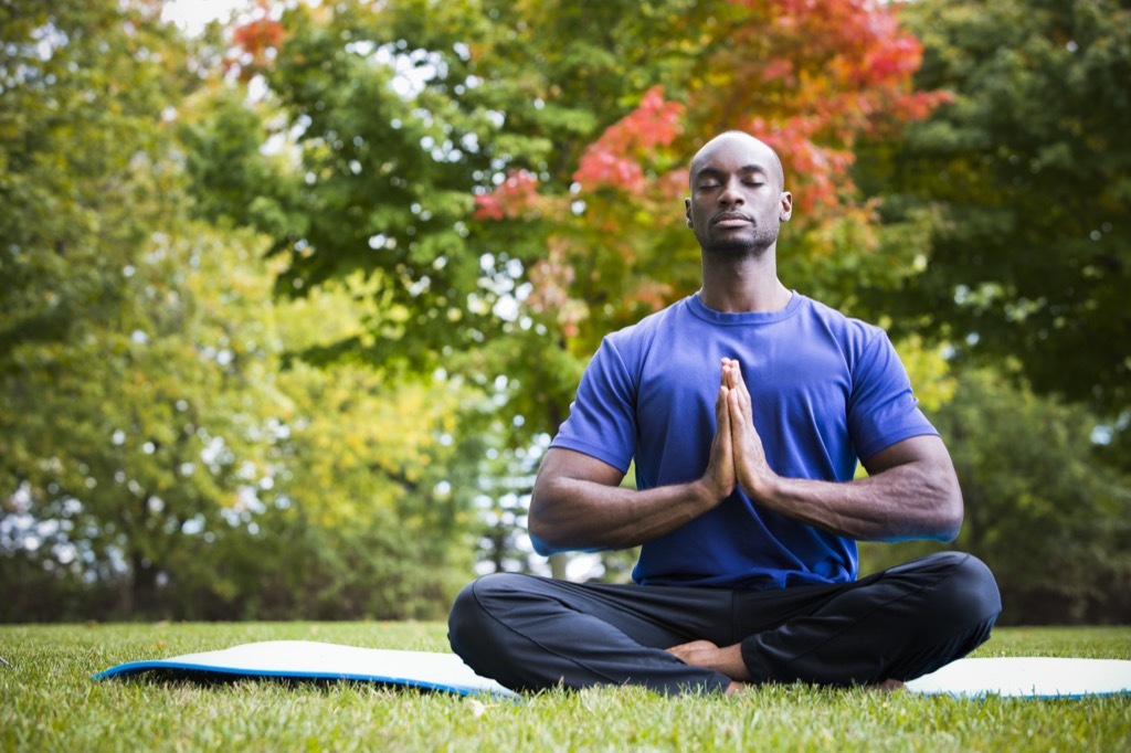 man meditating in the lawn