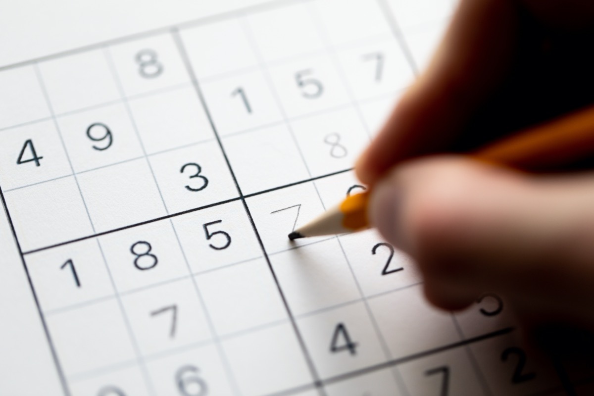 hand doing sudoku