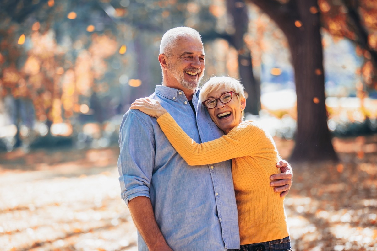 older couple laughing and walking together