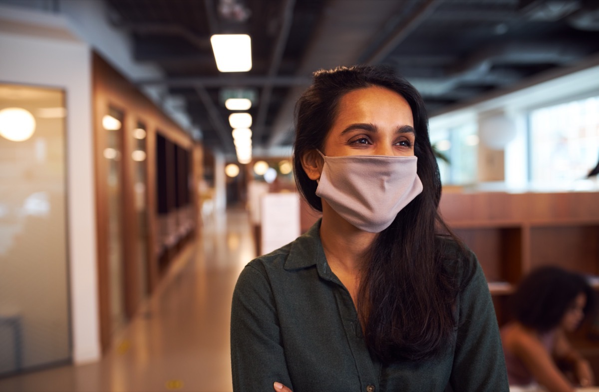 businesswoman wearing face mask in office.