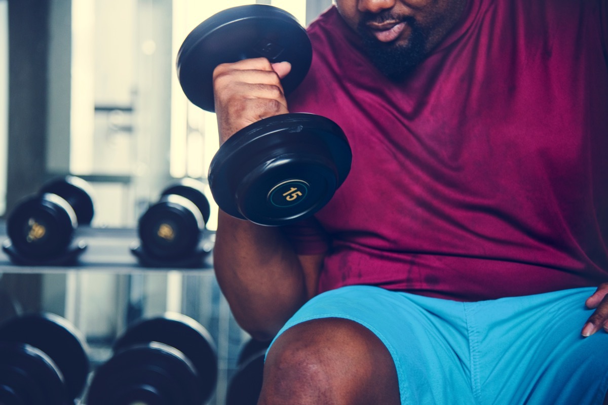 Man lifting weights and working out at the gym