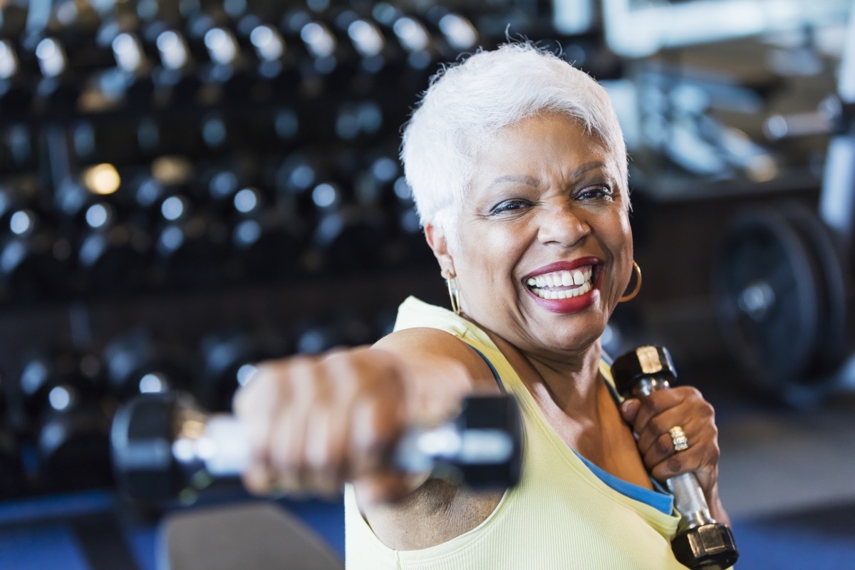 Older woman lifting weights at the gym