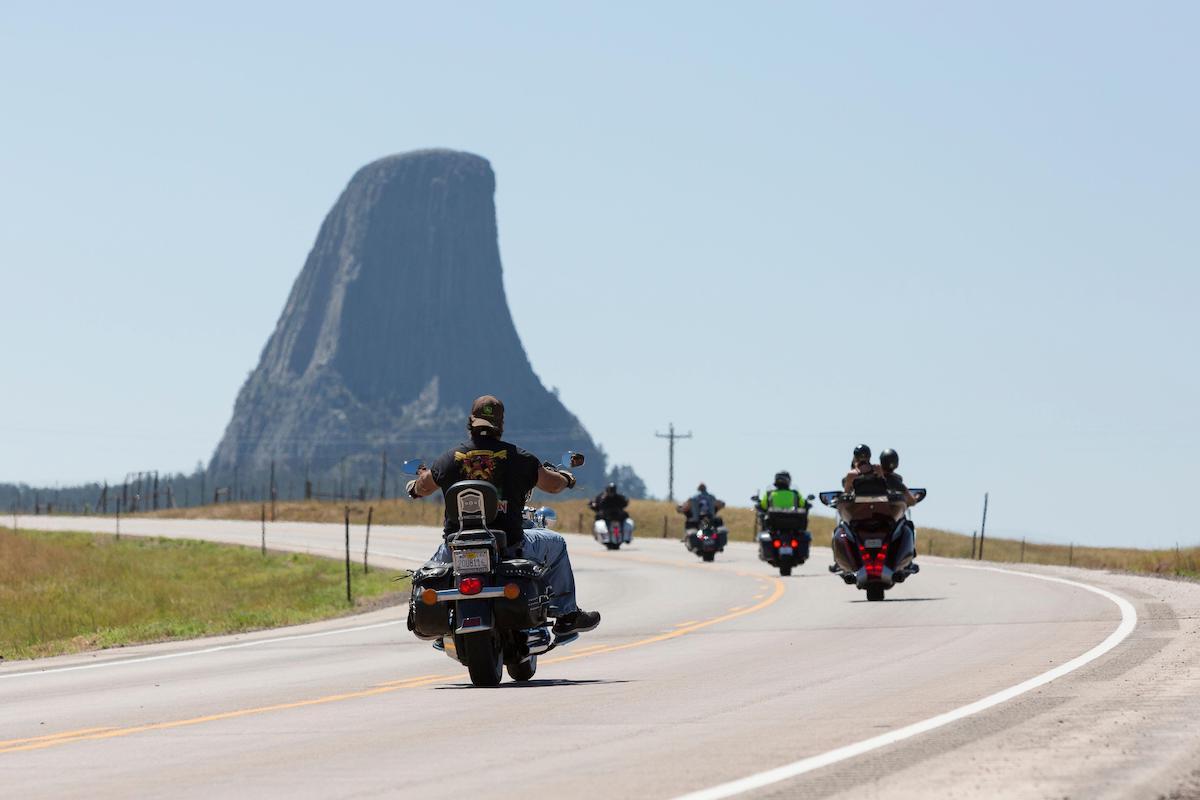 Bikers cruise along Highway 24 near Wyoming's Devils Tower on Friday, August 14, 2020. Every year, bikers who attend the nearby Sturgis Motorcycle Rally in South Dakota descend on the iconic landmark.